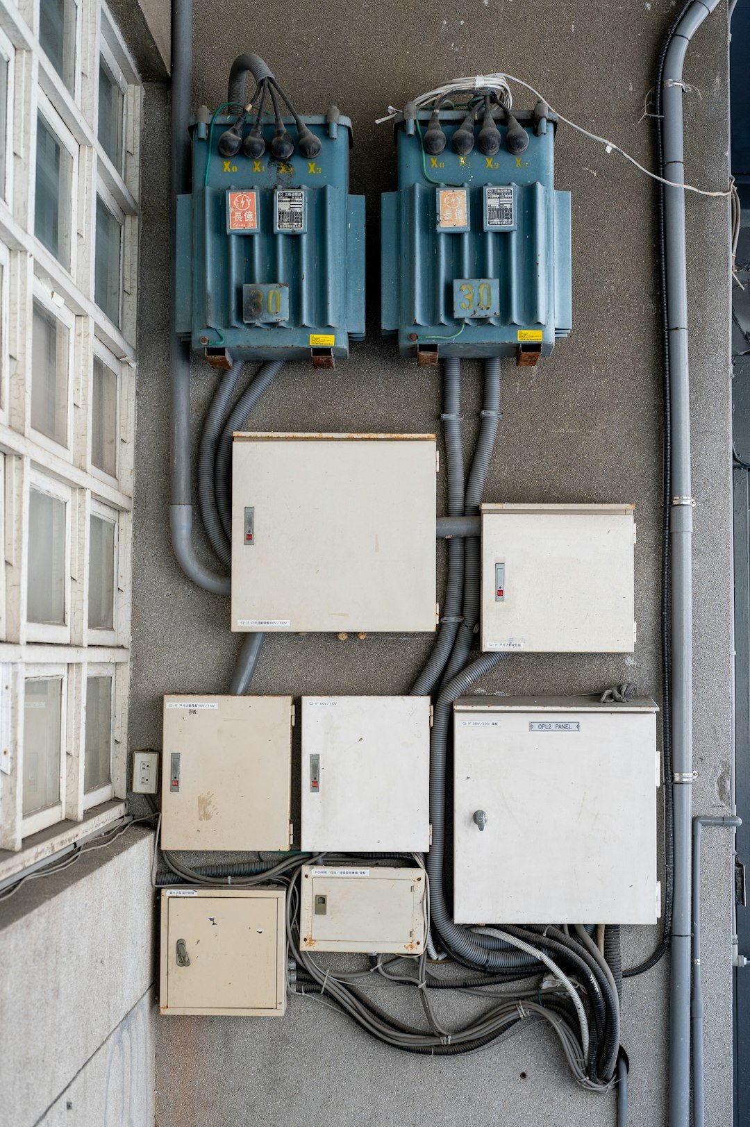 electrical-boxes-and-transformers-mounted-on-a-wall-uuxqz6twqd0